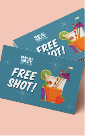 A stack of Holey Moley Golf Club free shot tickets on a light pink background.